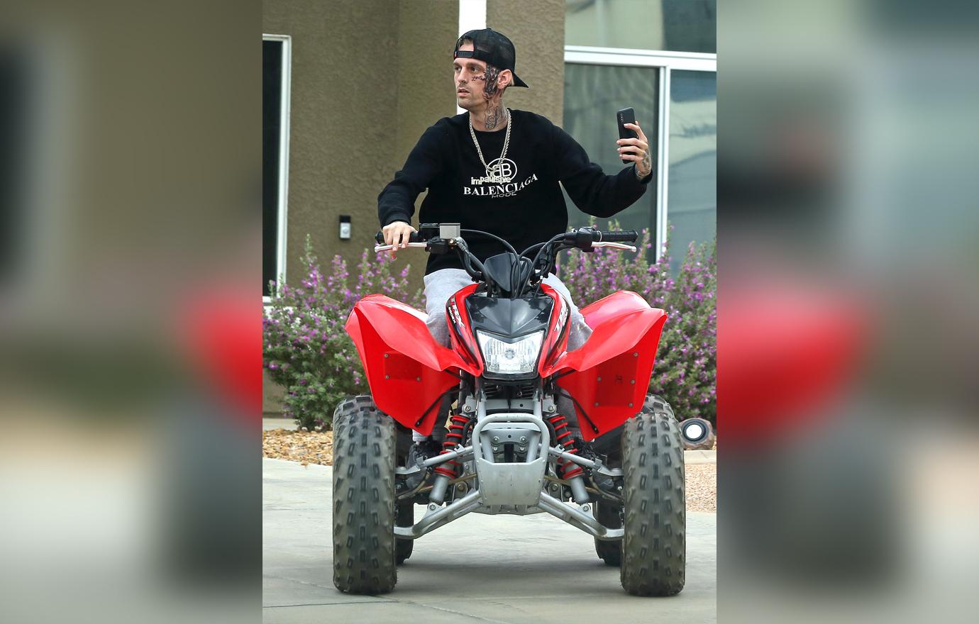 Troubled star Aaron Carter takes a ATV for a ride while sporting his new facial tattoo.