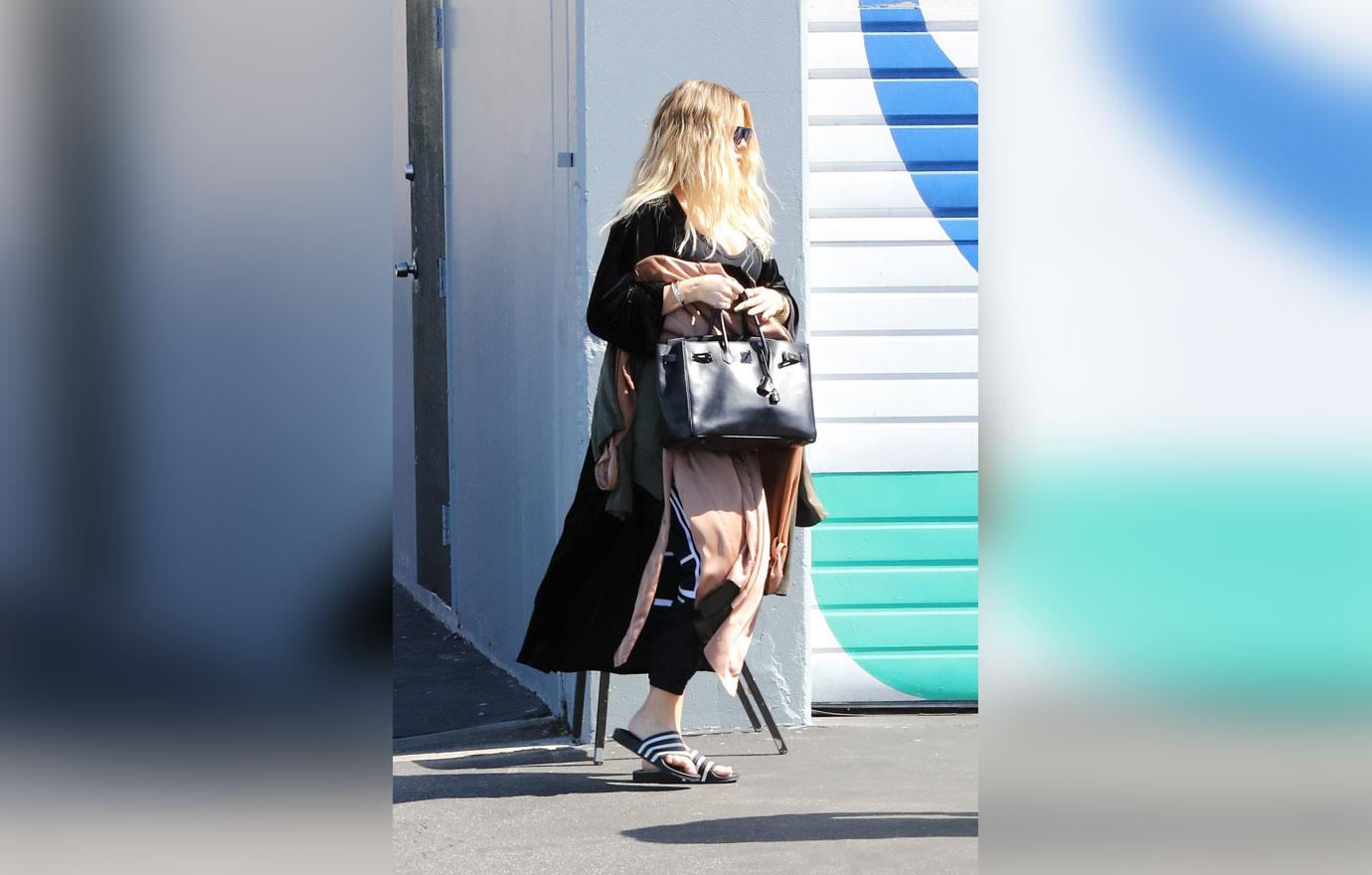 Khloe Kardashian covers baby bump