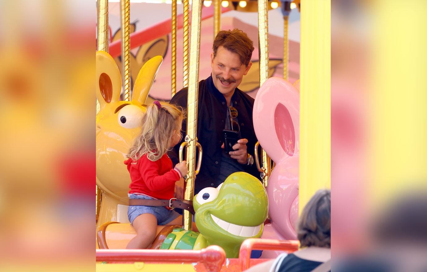 Bradley Cooper enjoys a day at Disneyland with his daughter Lea.