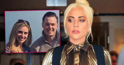 Lady Gaga Looking Left, Hair In A Bun, Wearing Gold Lame Shirt With Navy Blue Pants Suspenders, Inset Autumn Guzzardi Wearing Sunglasses On Her Head With Her Then Husband Dan Horton