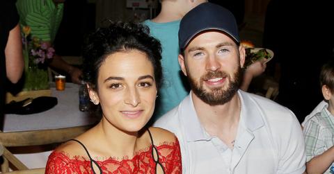 Jenny Slate wore a red dress with black spaghetti straps while Chris Evans donned a white Izod and a blue baseball hat.