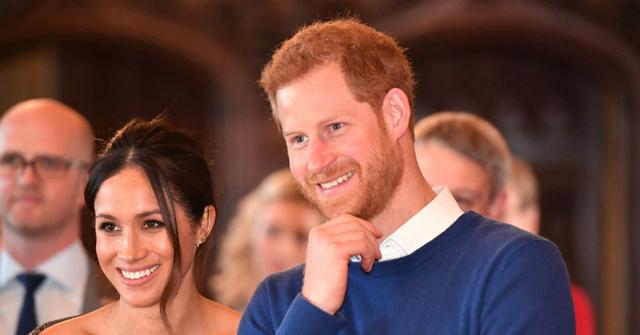 Meghan Markle wears a black and white off the shoulder dress with Prince Harry, dressed in a blue sweater, at Cardiff Castle.