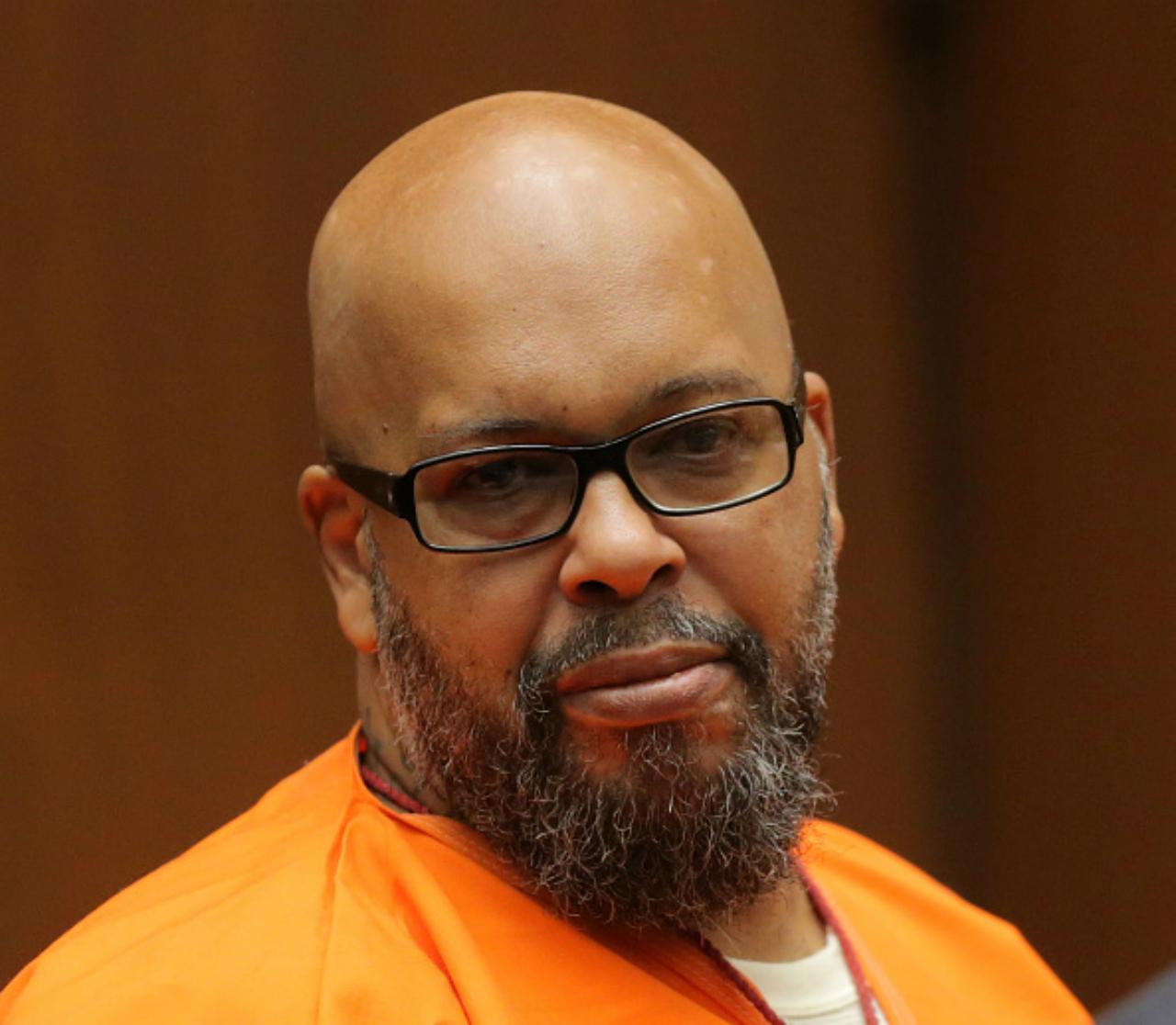 Suge Knight wears an orange prison jumpsuit during a court appearance.