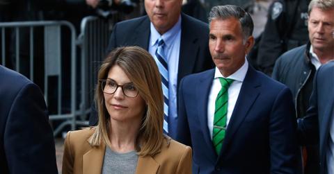 Actress Lori Loughlin, left, leaves as her husband Mossimo Giannulli, right, trails behind her outside of the John Joseph Moakley United States Courthouse in Boston