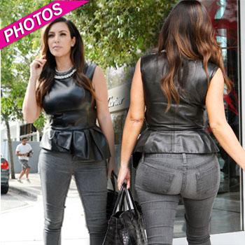 Kim Kardashian shows off her curves in skintight leather pants and