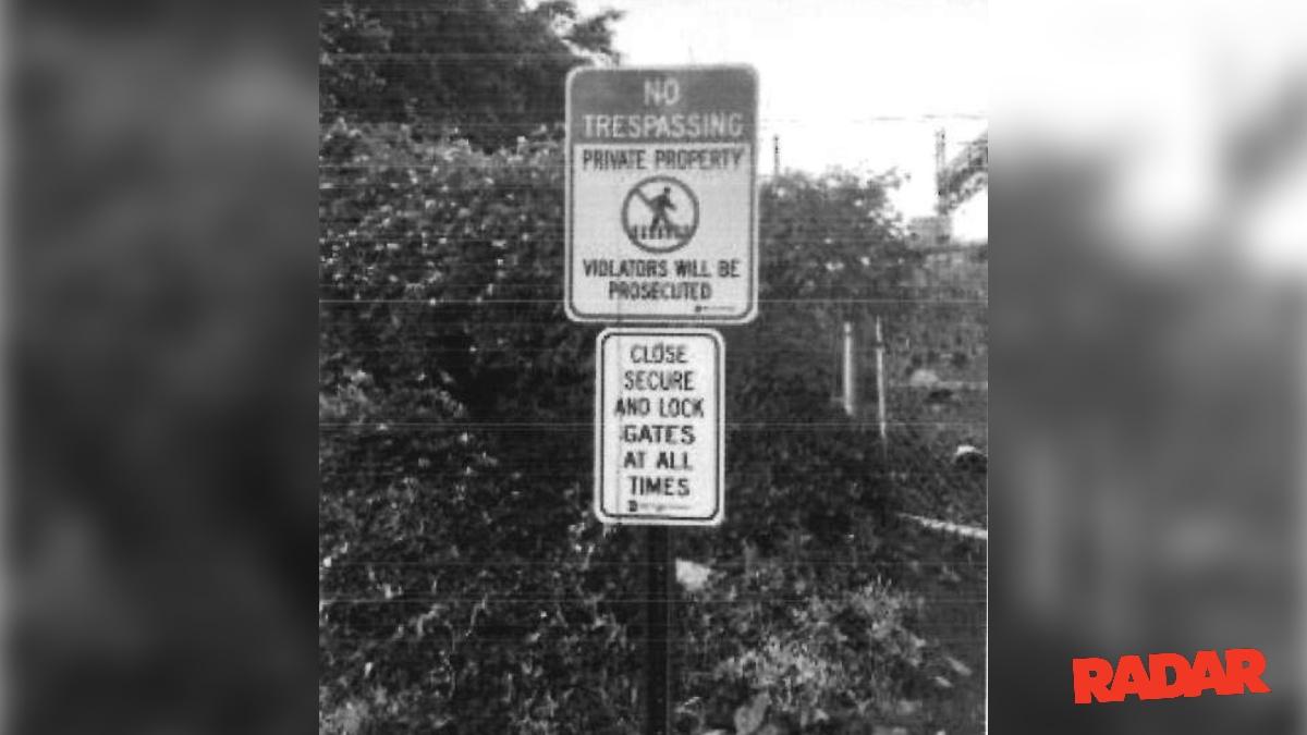 A photograph in the official police report shows a 'No Trespassing' sign.