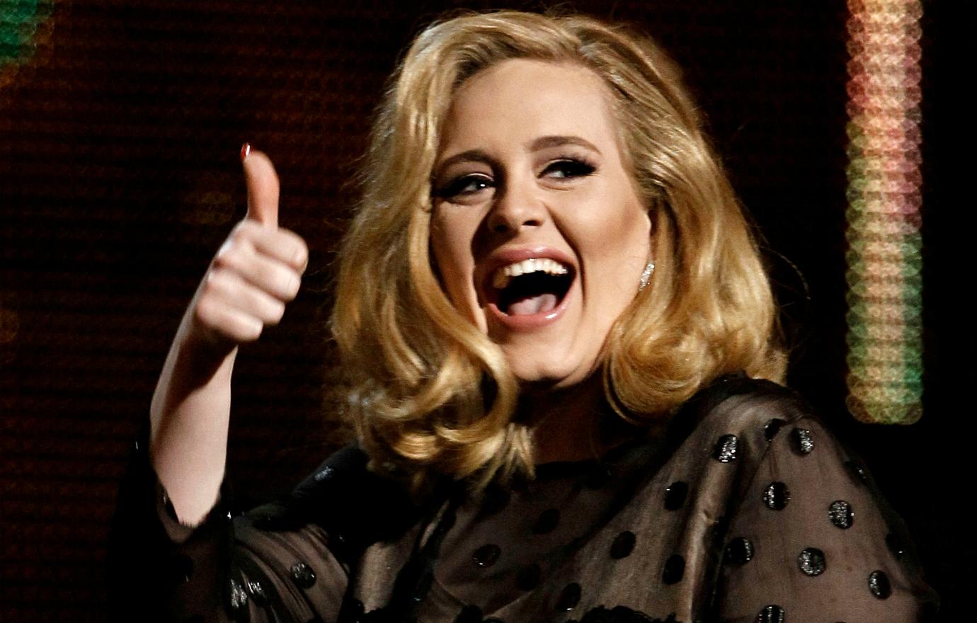 Adele gave the thumbs up after she won a Grammy and wore a black, lacy dress.