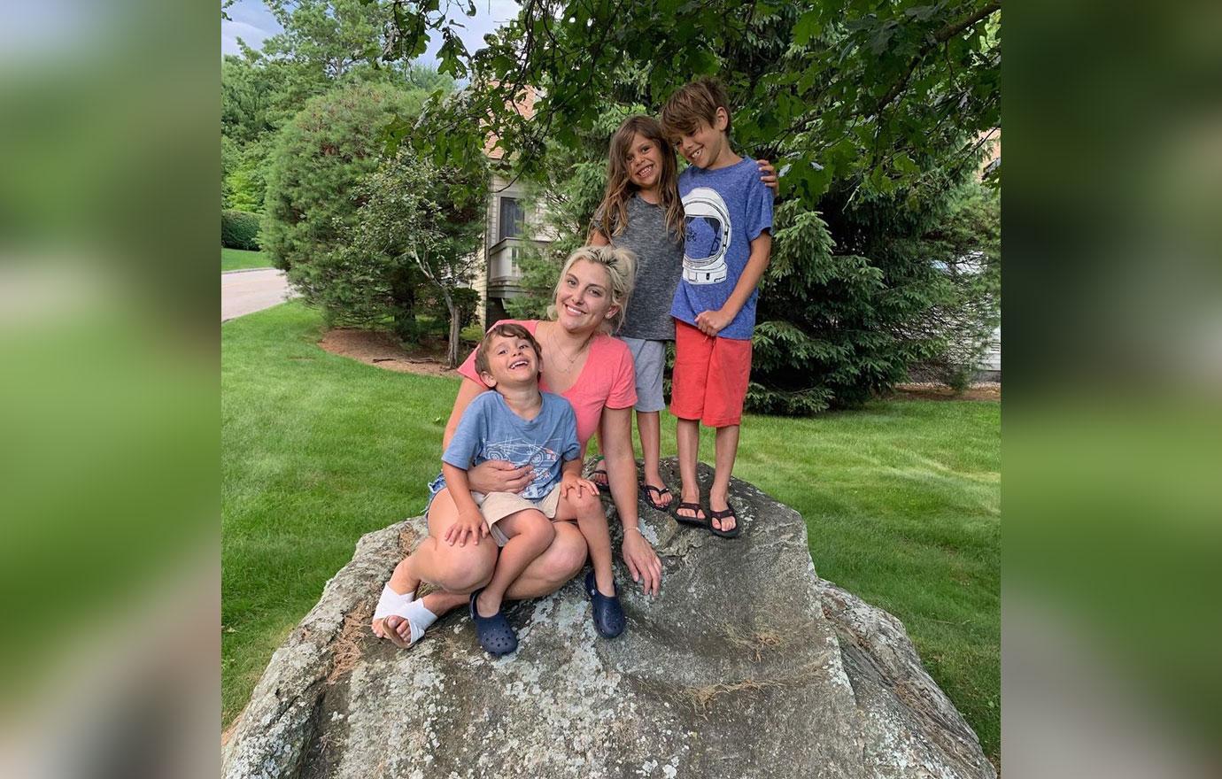 Gina Kirschenheiter with her children standing on a rock.