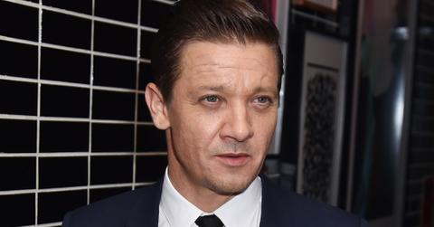 Jeremy Renner Wearing Black Tie and Dark Blue Suit With White Shirt