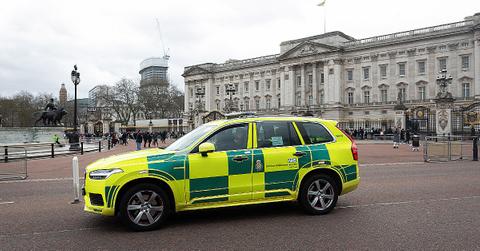 Composite picture of police car outside of Buckingham Palace