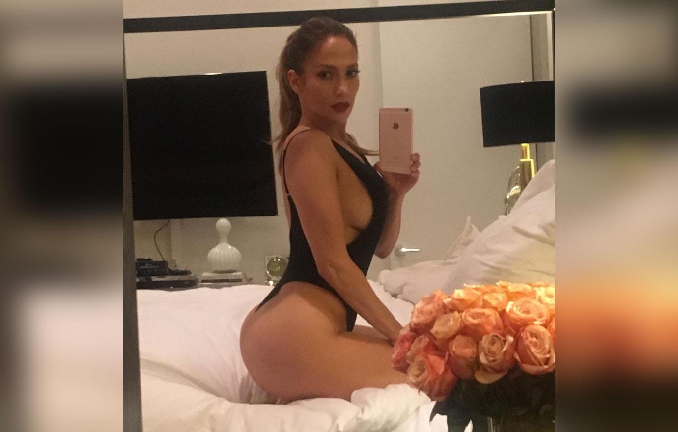 Jennifer Lopez takes a selfie wearing a black bikini.