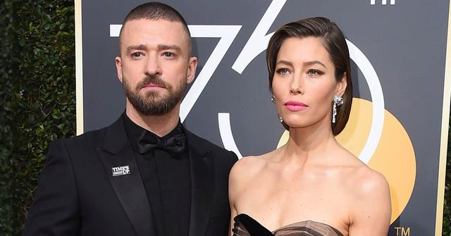 Justin Timberlake Black Tuxedo, Shirt, and Bow Tie With Jessica Biel Wearing Diamond Drop Earrings and Black Gown