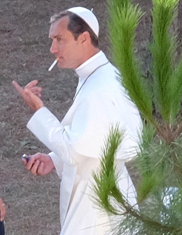 //jude law smokes cigarette dressed up as pope