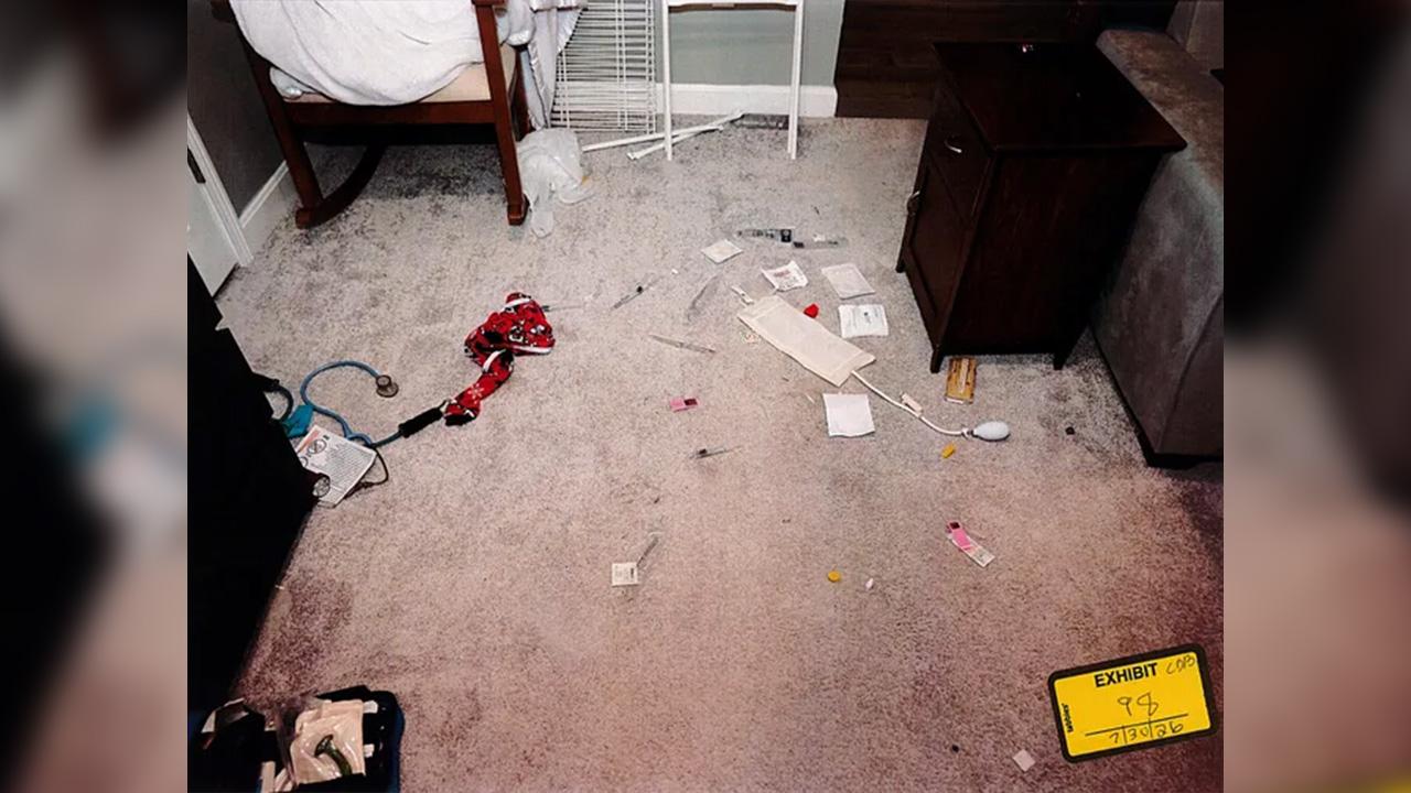 Toddler pajamas, some medical equipment and dried blood were on the floor.