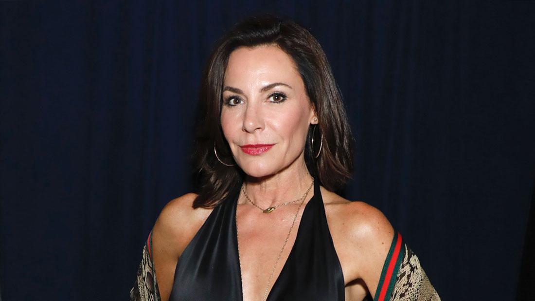 Luann de Lesseps Wearing Black Halter Jumopsuit With Gucci Scarf Around Her Arms