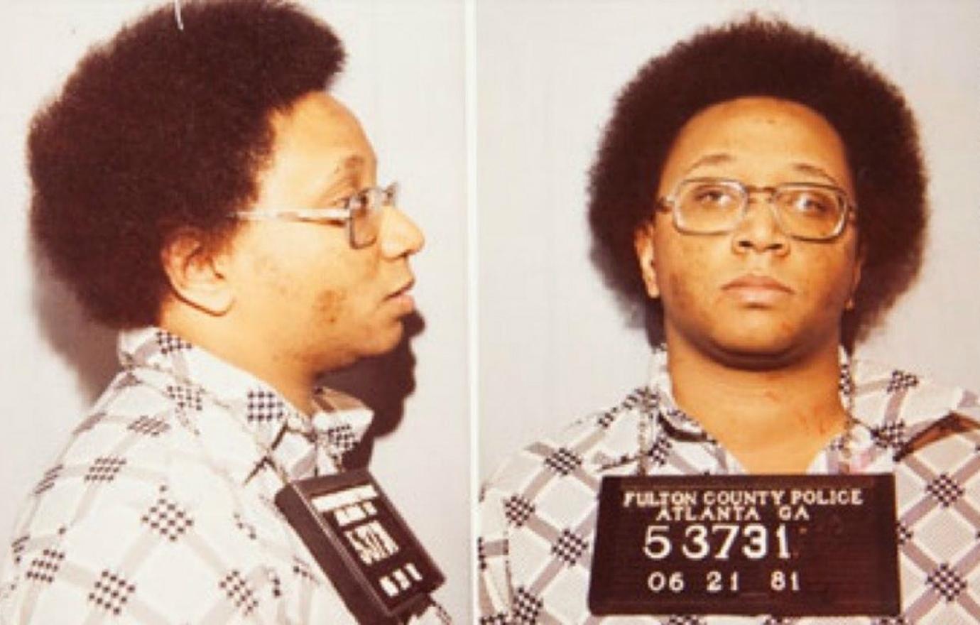 Wayne Williams looked bored in his patterned shirt in his mugshot after being arrested.