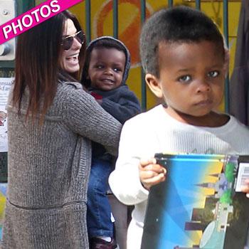 Sandra Bullock at the Super Bowl with son Louis sporting Baltimore