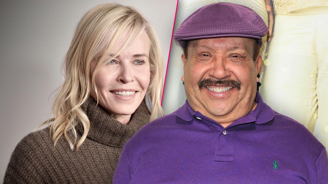 Smiling Chelsea Handler Wearing Brown Turtleneck Sweater, Smiling Chuy Bravo Wearing Matching Purple Golf Cap and Polo Shirt