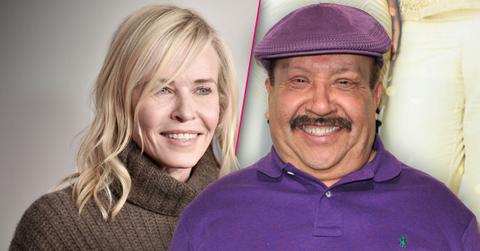 Smiling Chelsea Handler Wearing Brown Turtleneck Sweater, Smiling Chuy Bravo Wearing Matching Purple Golf Cap and Polo Shirt