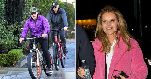 arnold schwarzenegger looks glum photos riding bike male friend maria shriver divorce settlement millions pp