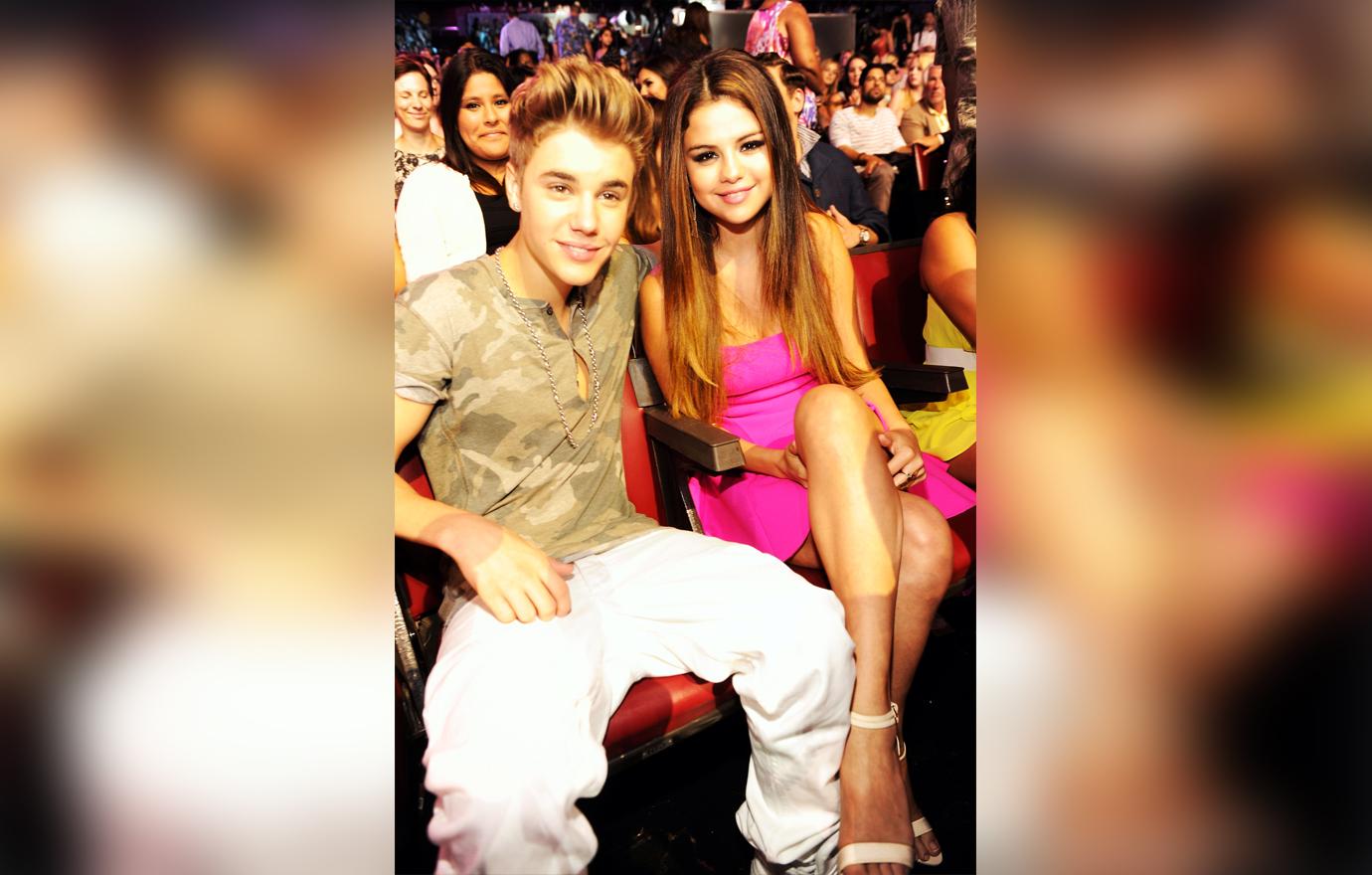 Justin Bieber Sits With His Arm Around Selena Gomez Sitting At Award Show
