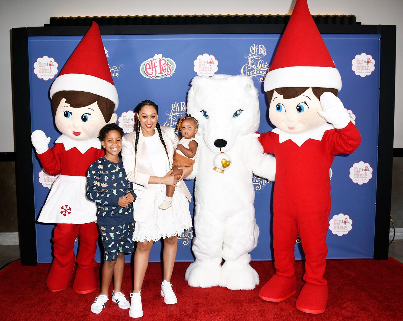 Tia Mowry and her children Cree Hardrict and Cairo Tiahna Hardrict posed with characters from Elf Pets A Fox Cub's Christmas Tale