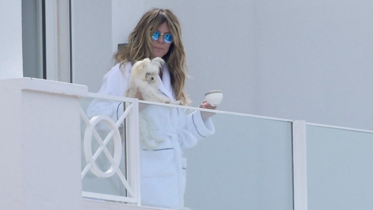 image of The supermodel wore only tiny thong bikini bottoms while lounging on a luxury hotel balcony.
