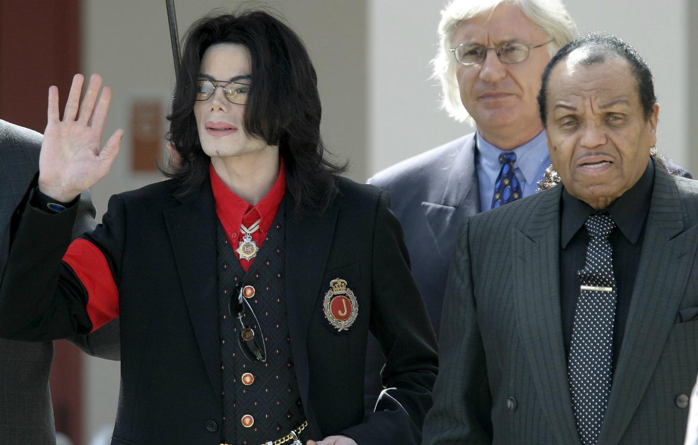 Michael Jackson wore a black suit with a royal emblem on the pocket, while his father Joe Jackson wore a pinstripe suit with a maroon tie.