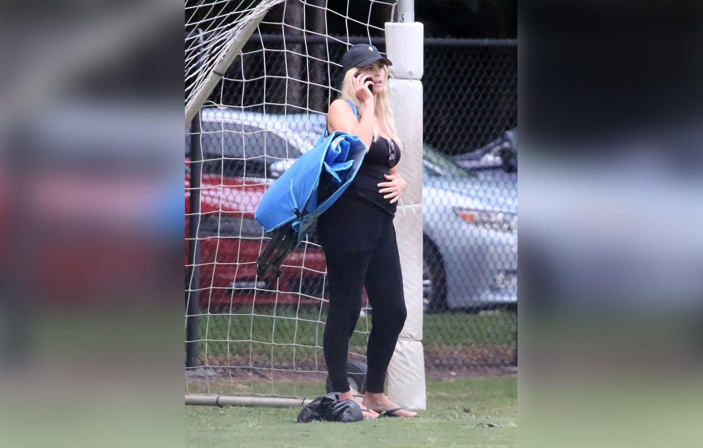 Elin Nordegren Wearing All Black Holding Pregnant Belly And Talking On The Phone at Her Son's Flag Football Game