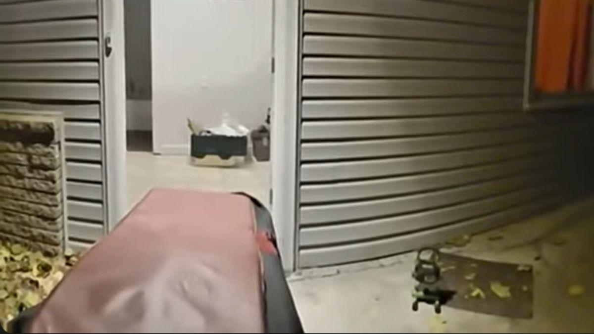 Body bags and stretchers were wheeled in and out of the house. 