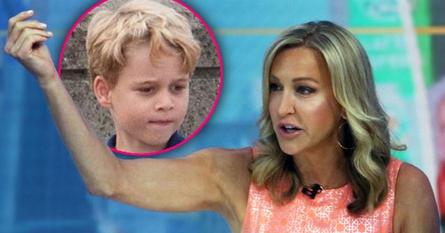Lara Spencer Looking Towards Inset Photo Of Prince George Wearing Patterned Peach Color Dress With Her Right Arm Extended