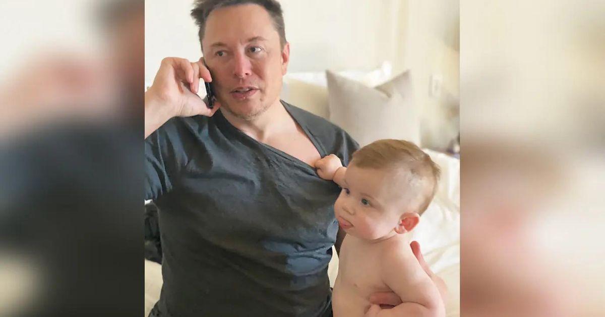 elon musk holding one of his children