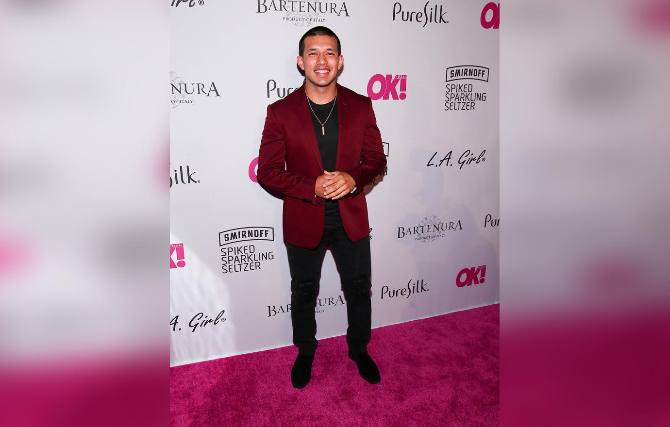 Javi Maroquin Smiling in Burgundy Blazer on Red Carpet