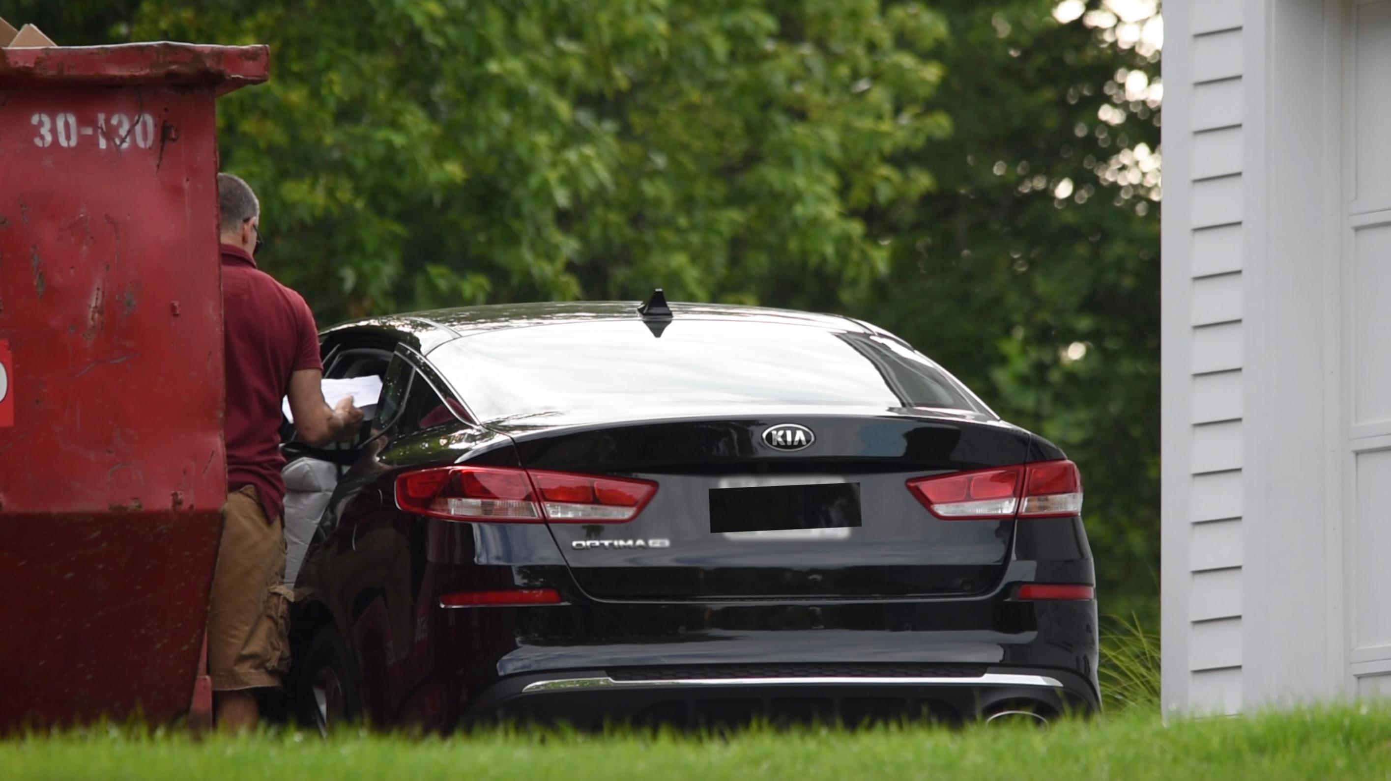 Fotis Dulos stands near his car.