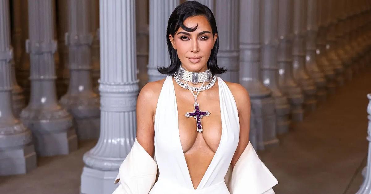 kim kardashian wearing princess diana cross necklace vulgar cleavage