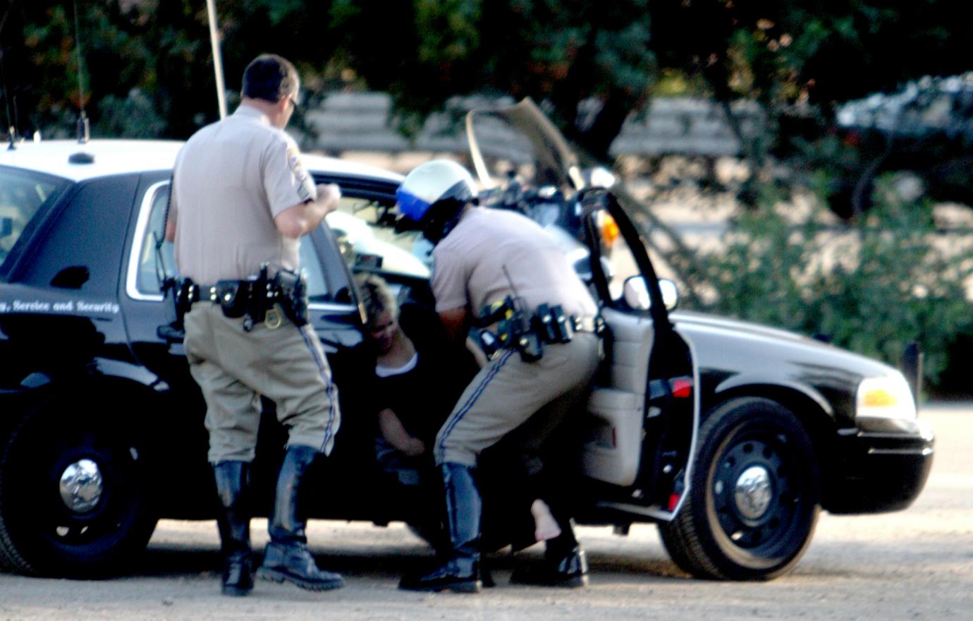 Heather Locklear is helped out of her car by police.