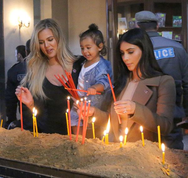 Kim & Khloe Kardashian Light A Candle In Armenia With North West