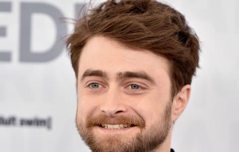 Daniel Radcliffe walked the red carpet in a black woven jacket over a black shirt.