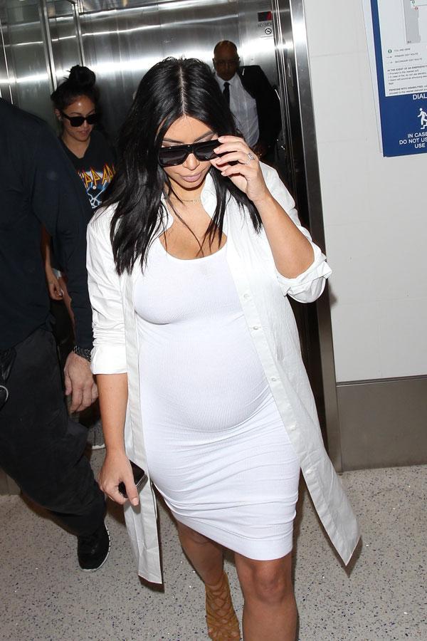 Kim Kardashian Flaunts Baby Bump In White Dress