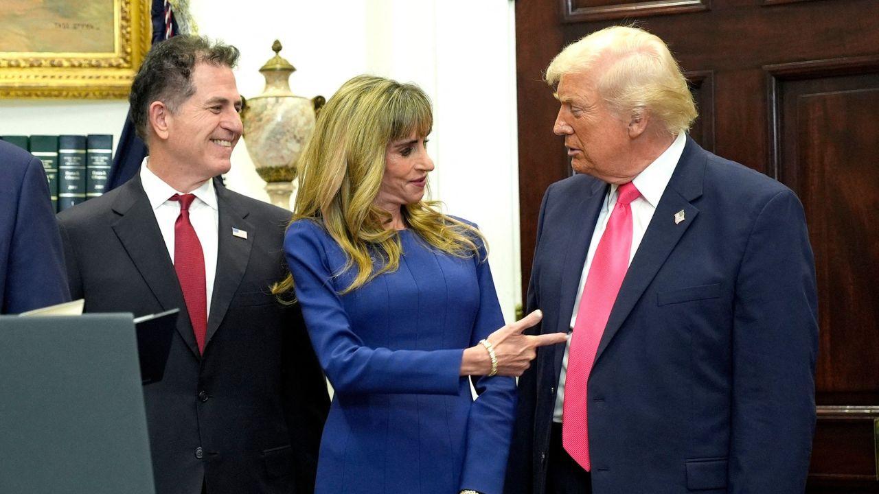 A photo of Michael Dell, Susan Dell, and Donald Trump