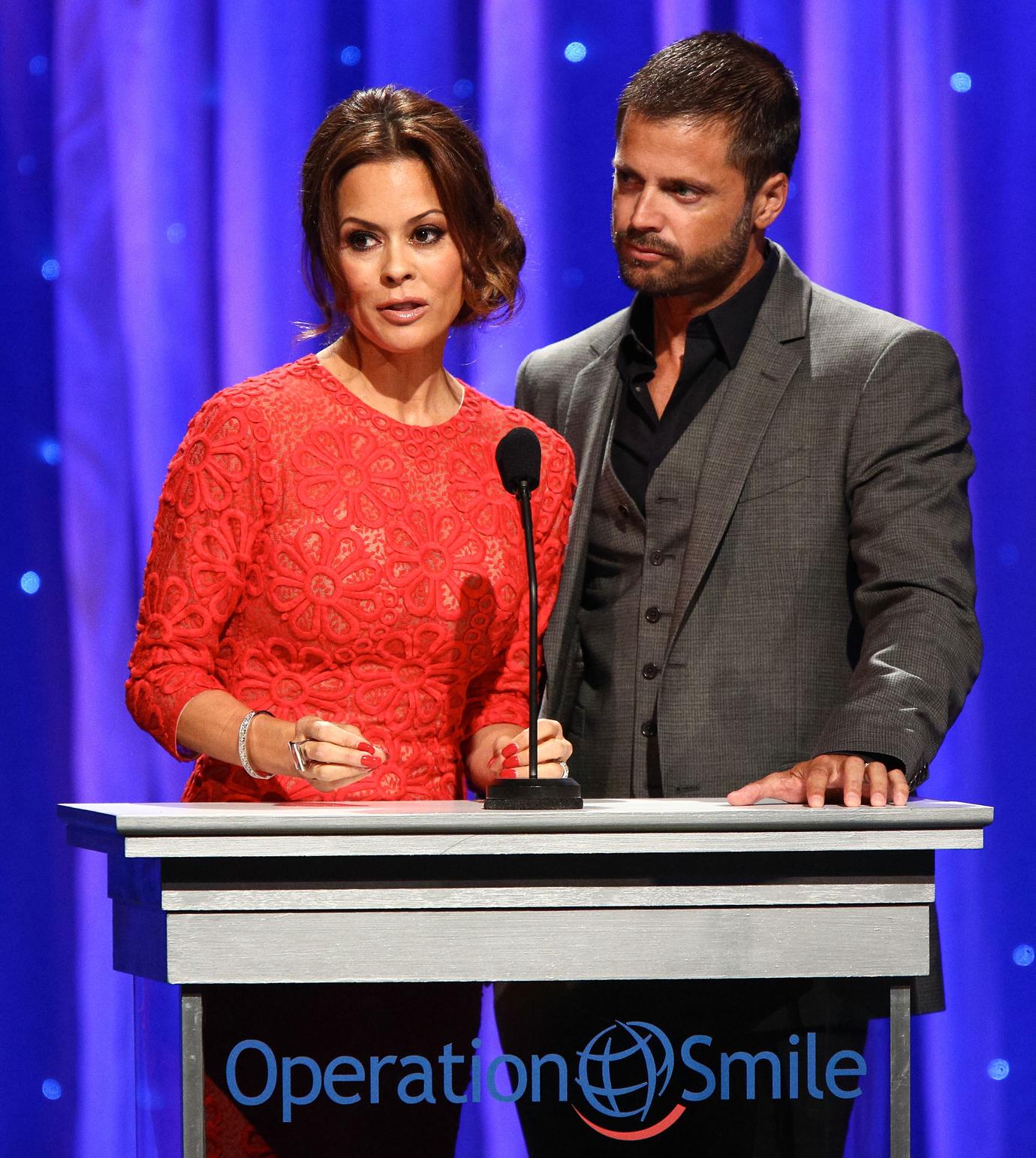 Television personality Brooke Burke-Charvet (L) and her husband, actor David Charvet, speak onstage at Operation Smile's 2013 Smile Gala at the Beverly Wilshire Four Seasons Hotel on September 27, 2013 in Beverly Hills, California.