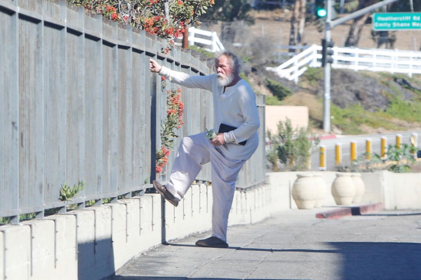 //Nick Nolte Climbs Fence Photos