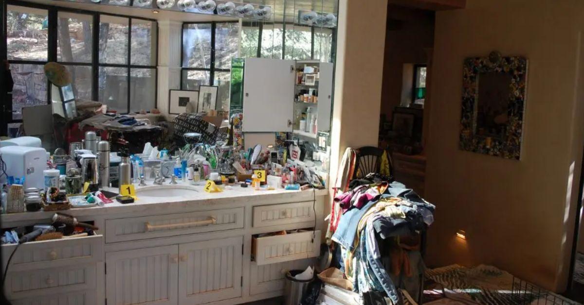 A sink was covered with various toiletries.