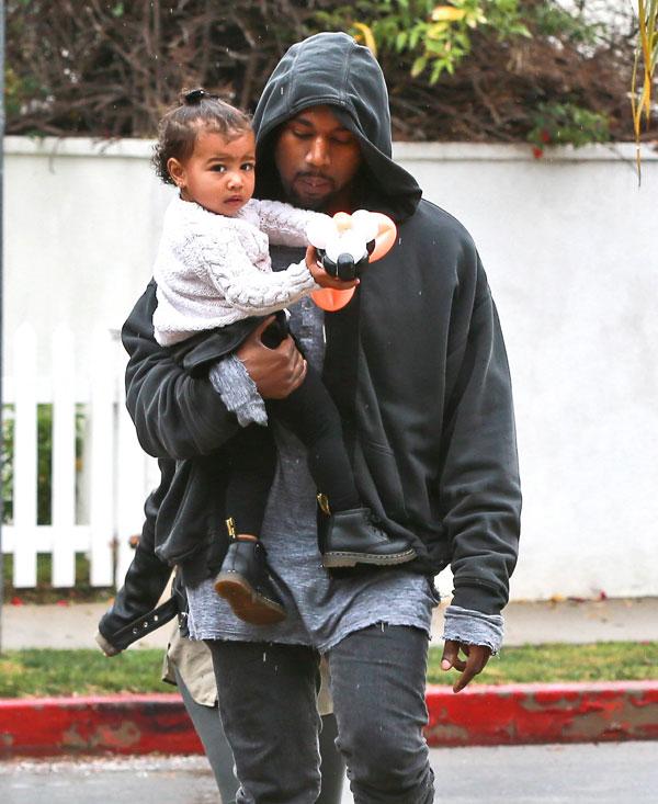 Kanye Kisses North West