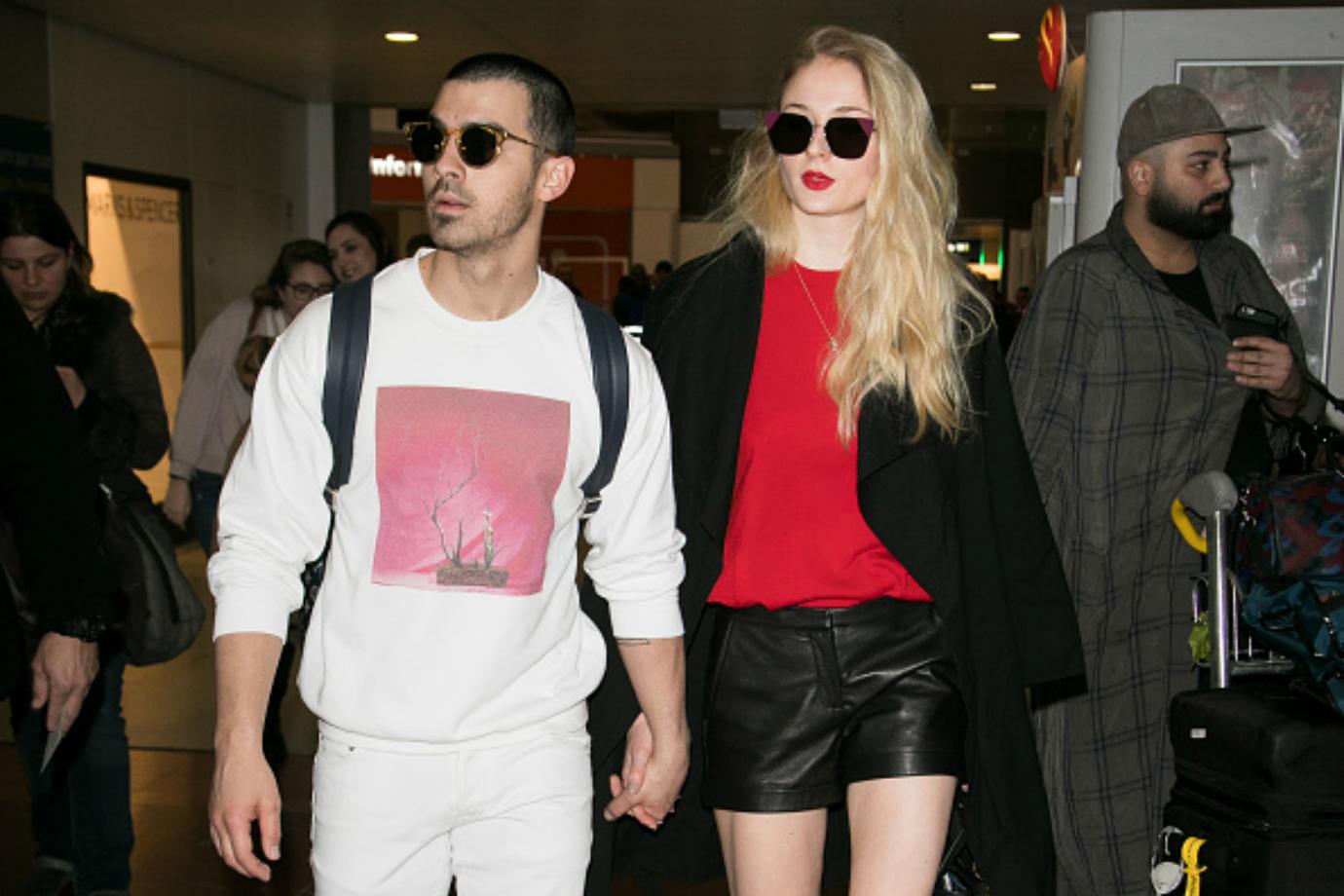 Joe Jonas and Sophie Turner walk hand in hand.