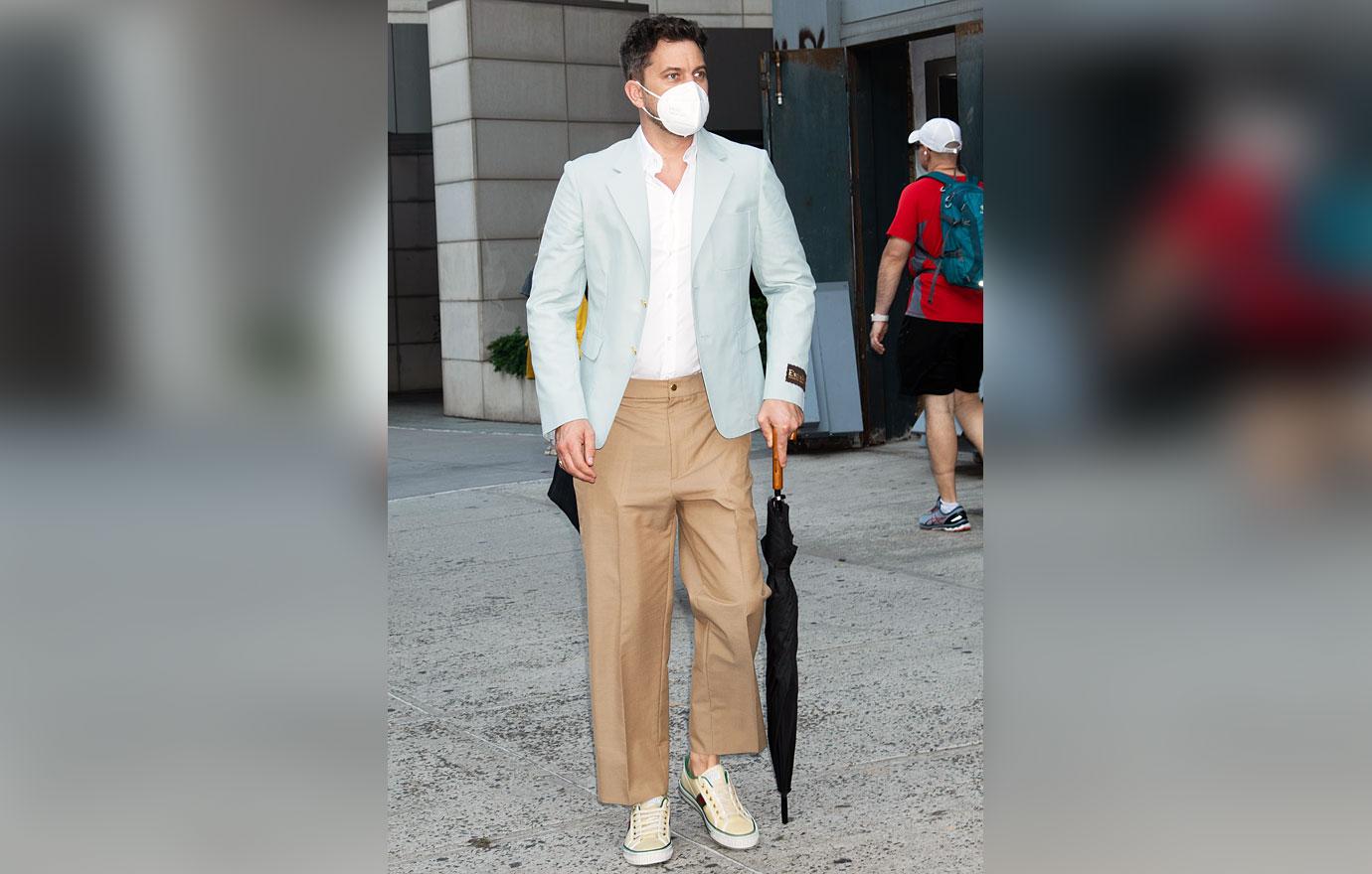 joshua jackson walking with umbrella