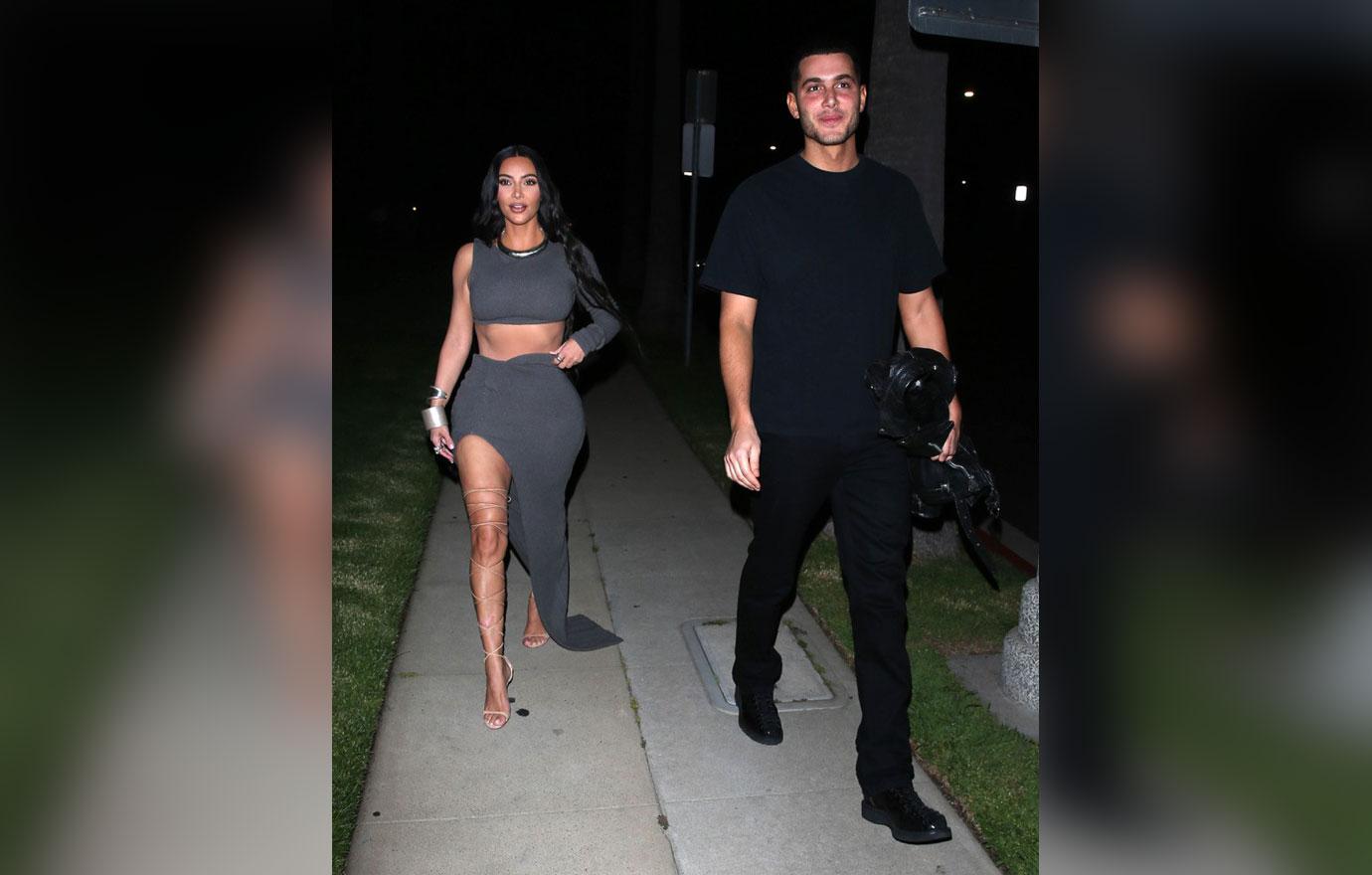 kim kardashian in a skintight outfit and roman gladiator style strappy heels arrives birthday party in beverly hills