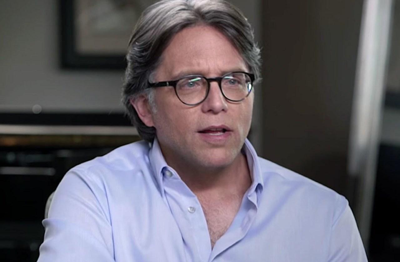 Keith Raniere Closeup Looking Serious in Light Purple Shirt and Glasses