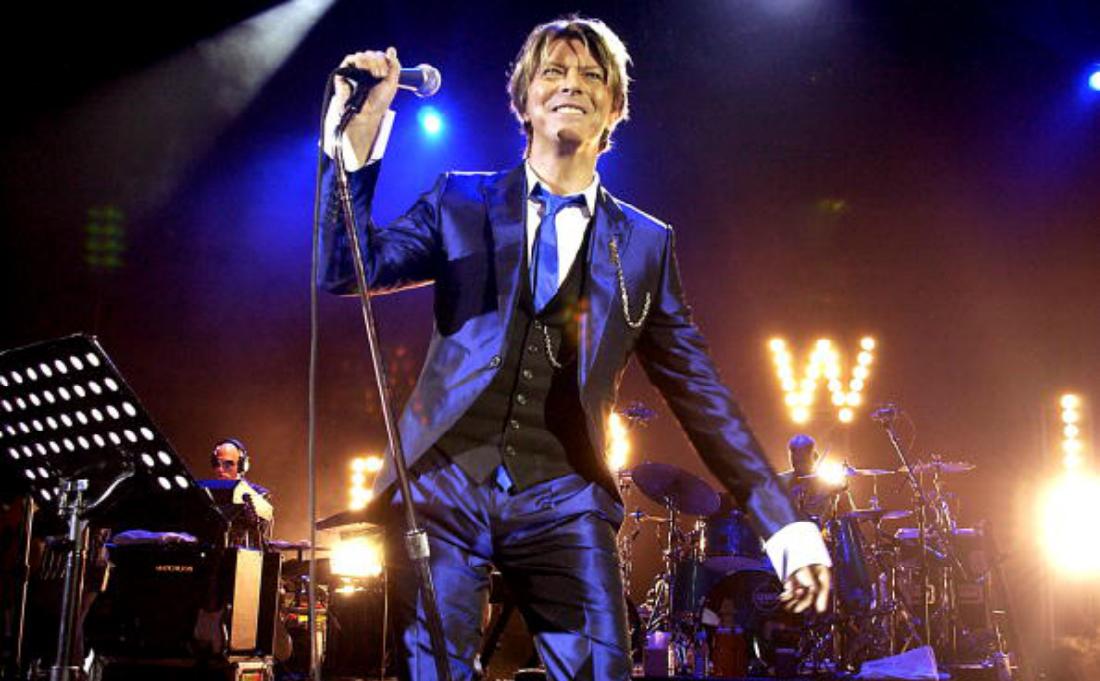 David Bowie performs on stage.