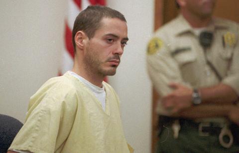 Robert Downey Jr. at his Chinese Theatre handprint induction ceremony where he wore a grey blazer with a red T-shirt underneath with Scarlett Johansson next to him.